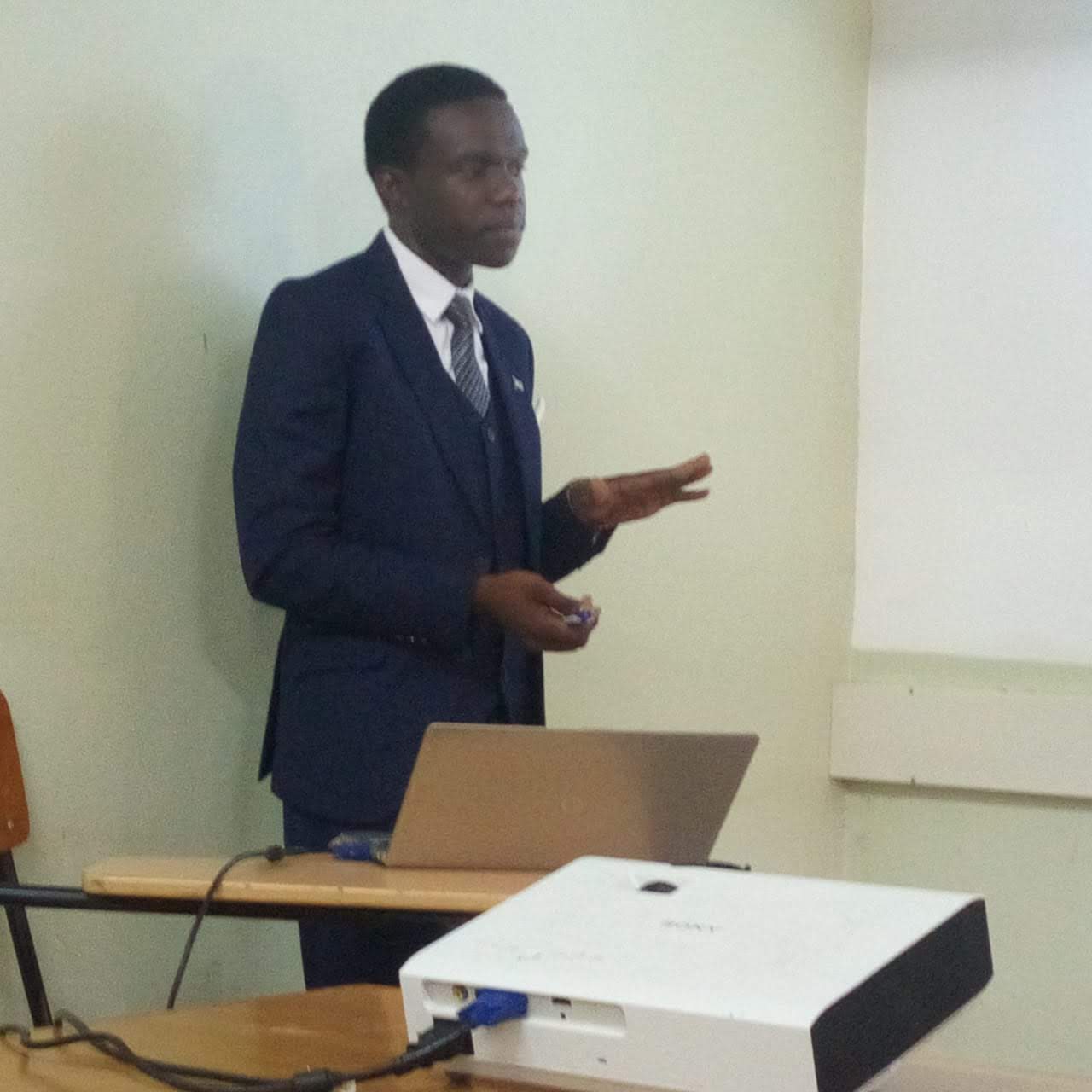 Martin Litu 5th year student presenting his project to panel team and students.